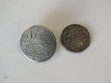 two coins that are sitting next to each other on a table