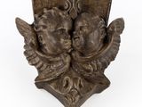 pair of cheren angels on a shield with wings on a white background