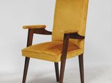 a close up of a chair with a yellow upholstered seat