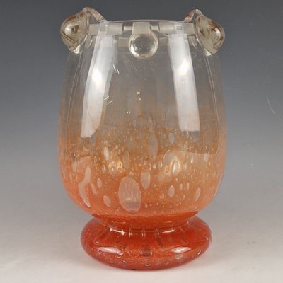 a glass vase that has a handle on it