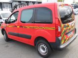 a red van that is parked in a parking lot