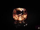 an orange diamond on a black surface