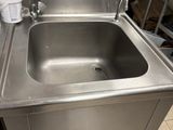a stainless steel sink with a faucet in the corner