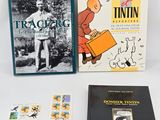 three books are sitting next to each other on a white surface