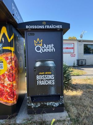 a black box with a pizza on it in front of a building
