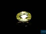 a yellow sapphire stone on a black background