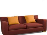 an image of a red couch with two yellow pillows on it