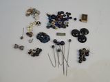 many different types of buttons and pins on a table