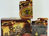 three indiana jones action figures in boxes on a white surface