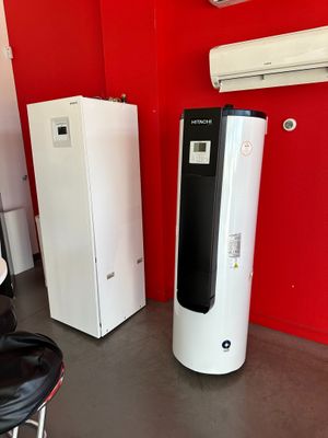 two refrigerators and a refrigerator freezer in a red room