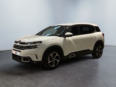 the white suv is parked in a room with a gray floor