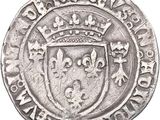 a close up of a silver coin with a crown on it