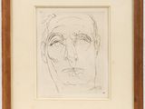 un dessin représentant le visage d'un homme, dans un cadre en bois