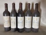 four bottles of wine are lined up on a table