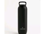 a black water bottle sitting on top of a white surface