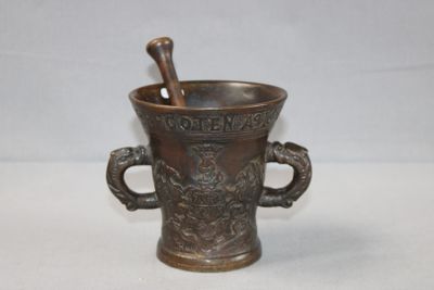 a metal cup with a spoon in it on a table