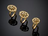 three gold rings on a black surface