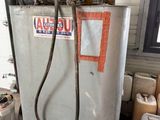 a gas tank with a hose attached to it in a garage
