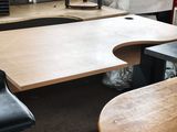 tables and chairs in a room with a fire place in the background