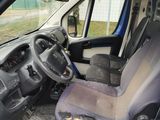 a blue van with a black seat in the back of it