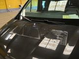 a car that has a lot of papers on the hood