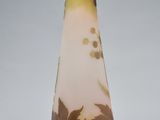 a glass vase with a brown and yellow design on it