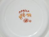 a plate with a picture of an elephant and a giraffe on it
