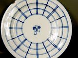 a blue and white plate with a clock on it