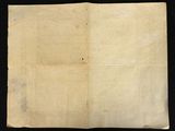 an old piece of paper on a black surface