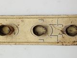a close up of a metal plate with three buttons on it