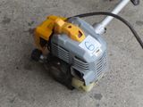 an image of a close up of a small engine on the ground