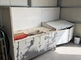 a white refrigerator and a freezer in a garage