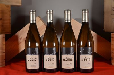 three bottles of wine are lined up on a table