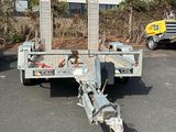 an image of a flatbed trailer parked in a parking lot