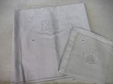 a white cloth with a monogram on it next to a white cloth with a monogram on it next to a white cloth with a monogram