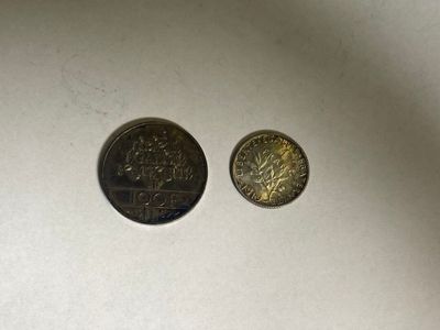 two coins that are sitting next to each other on a table