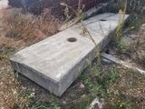a concrete block sitting in the middle of a field