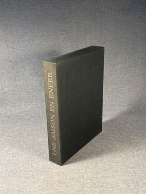 a black book sitting on top of a gray surface