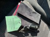 a car key and a wallet on the seat of a car