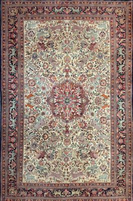 an antique persian rug with a floral design on a blue background