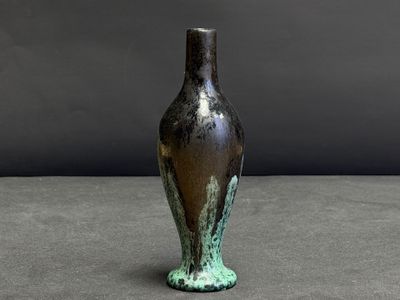 a vase that is sitting on a table with a gray background