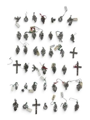 many different types of earrings on display on a white surface