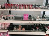 a lot of makeup products on the shelves in the store