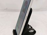 a tablet that is sitting on a stand on a table