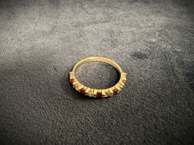a close up of a gold ring on a black surface