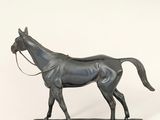 statue of a horse on a black base with a white background