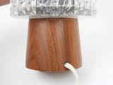 a person holding a piece of plastic over a wooden object