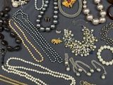 an assortment of assorted necklaces and bracelets on a table