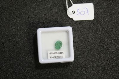 a small white box with a green stone in it
