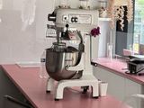 a mixer on a counter in a kitchen with a pink counter top